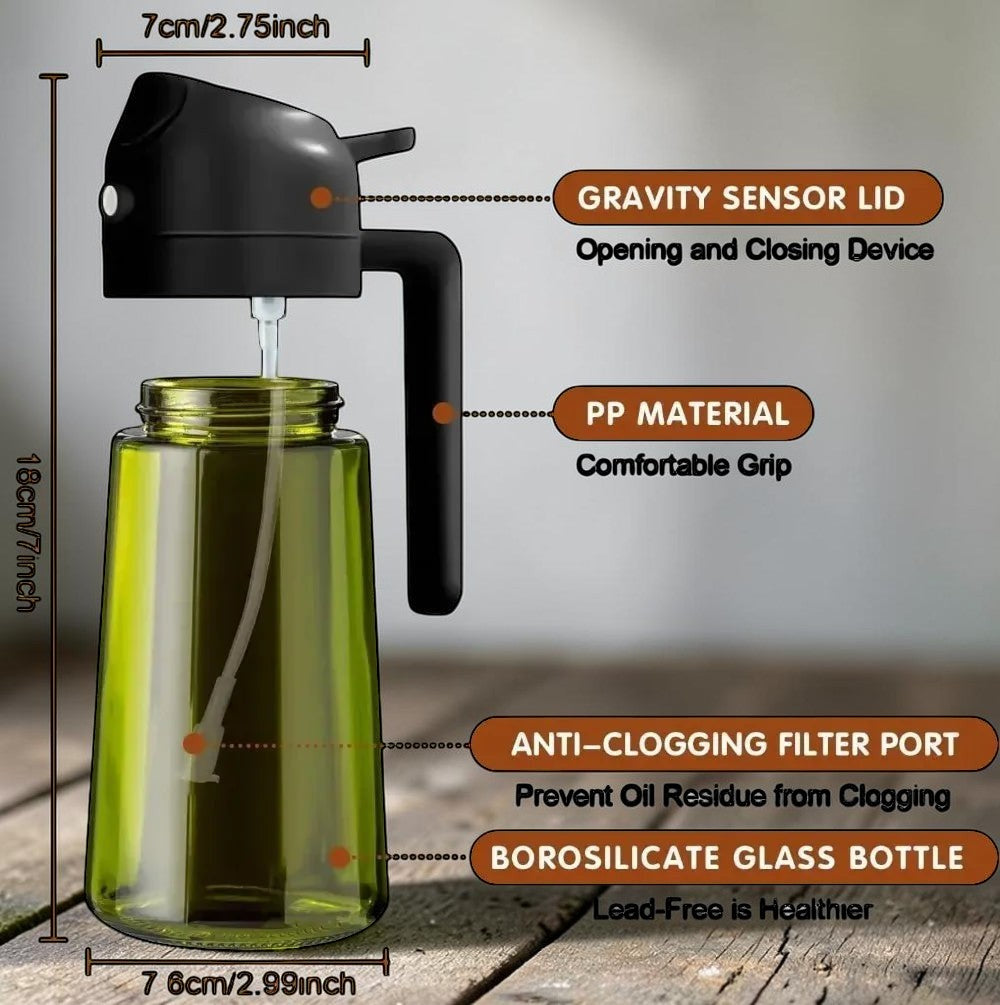 The OmniPour™ green borosilicate glass oil mister with black handle and gravity sensor lid for even misting.